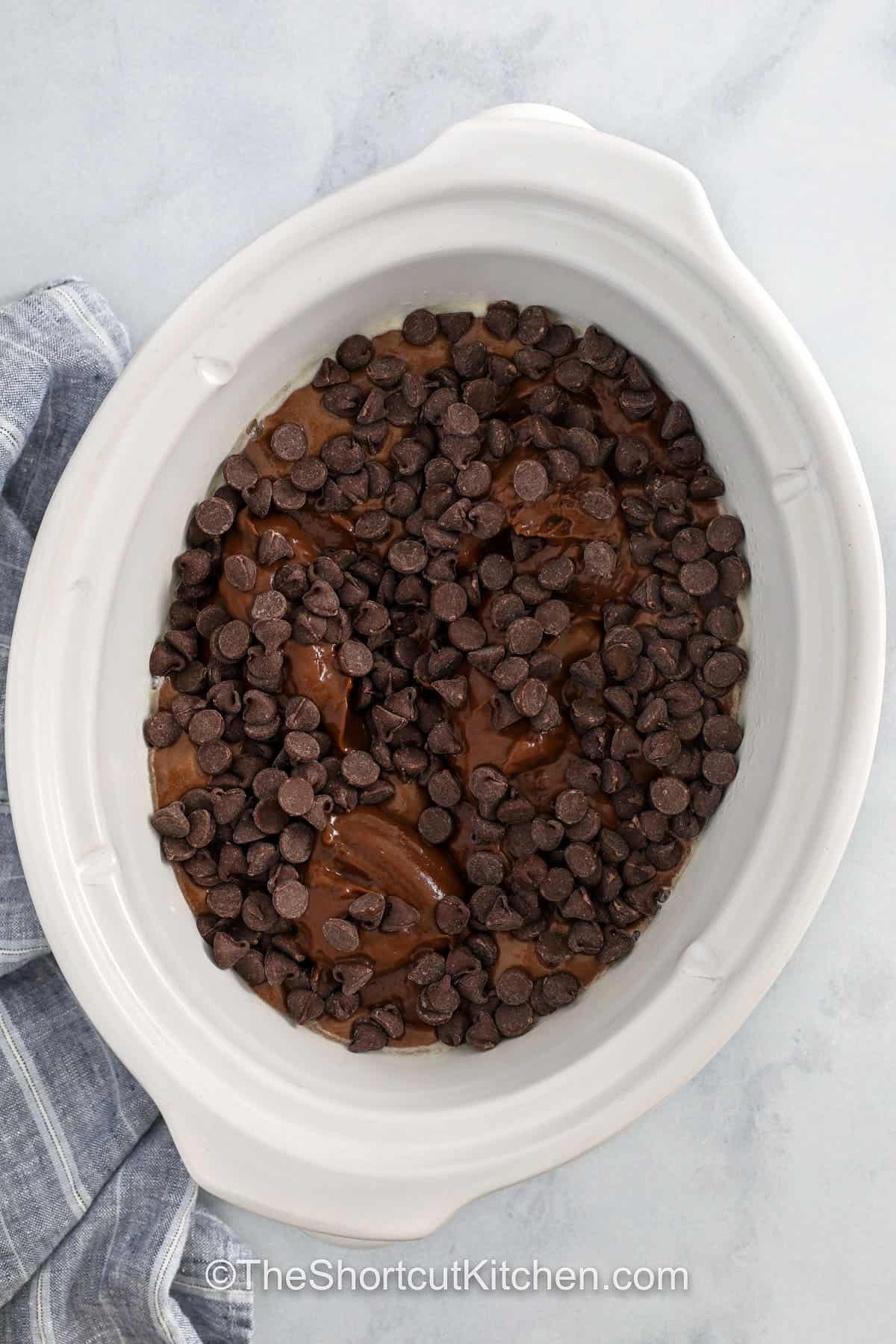 adding chocolate chips to crockpot to make Crockpot Lava Cake