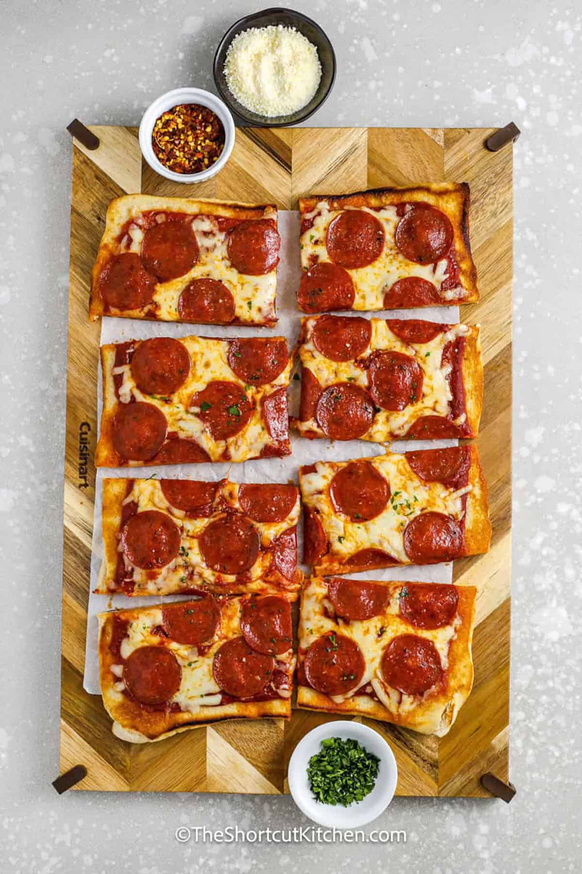 Grilled Pizza cut into slices on a cutting board