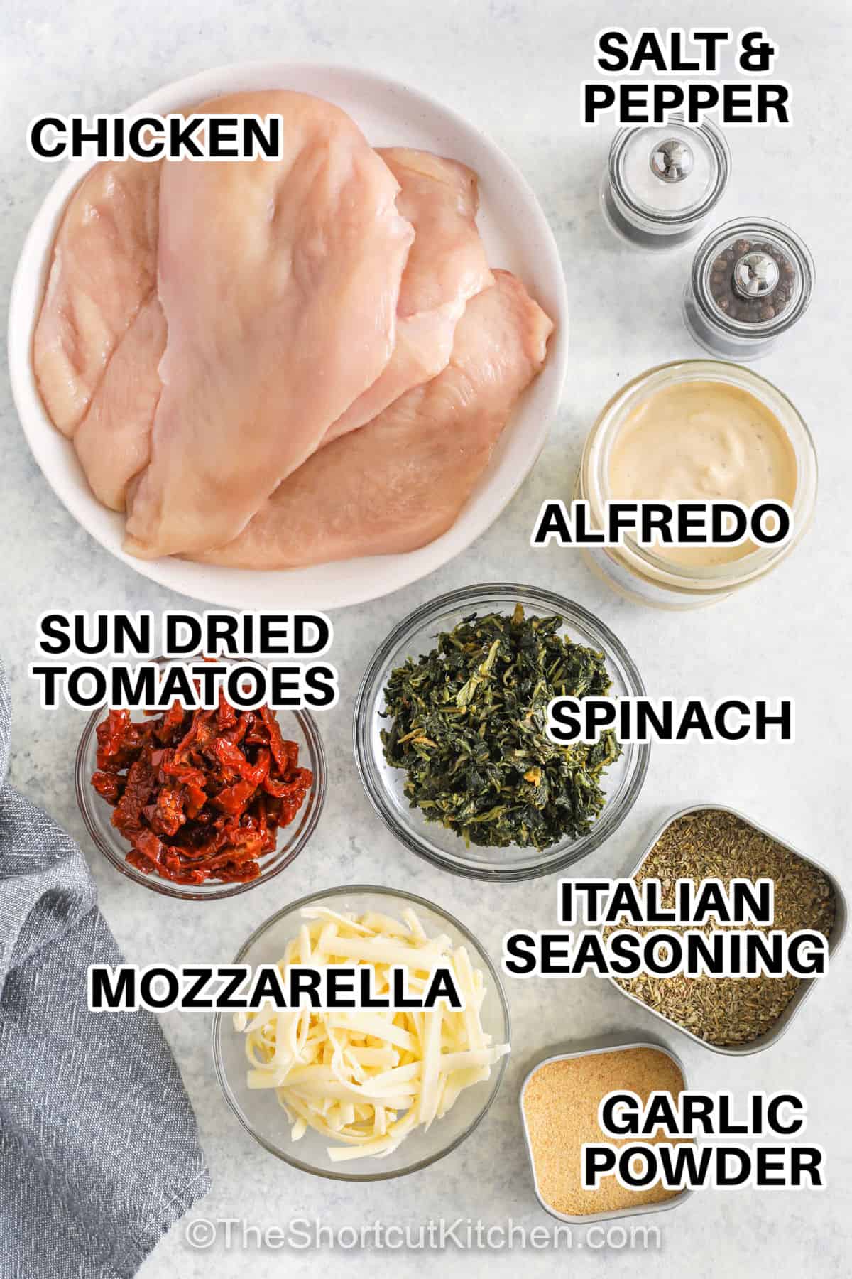 chicken , sun dried tomatoes , mozzarella , garlic powder , italian seasoning , spinach , alfredo sauce , salt and pepper with labels to make Baked Tuscan Chicken