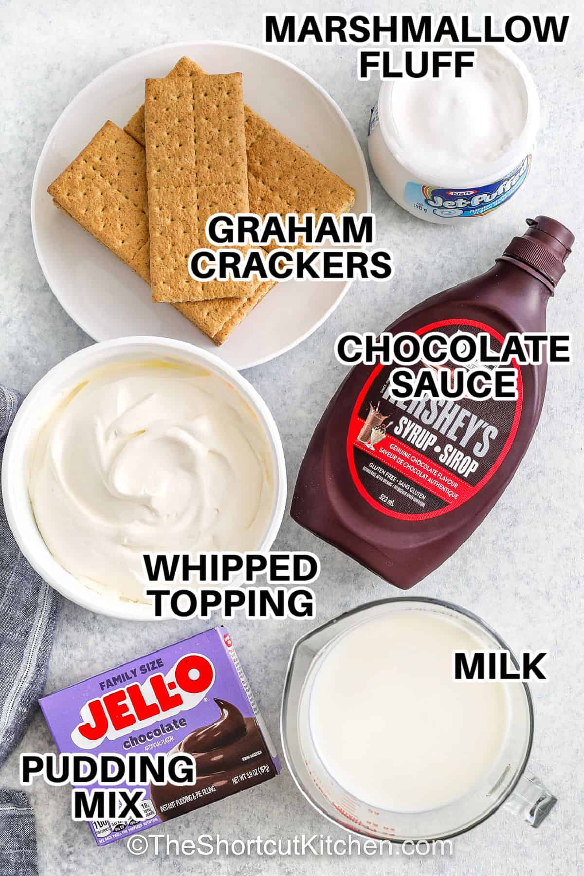 marshmallow fluff , graham crackers , chocolate sauce , whipped topping , pudding mix and milk with labels to make Frozen S'mores