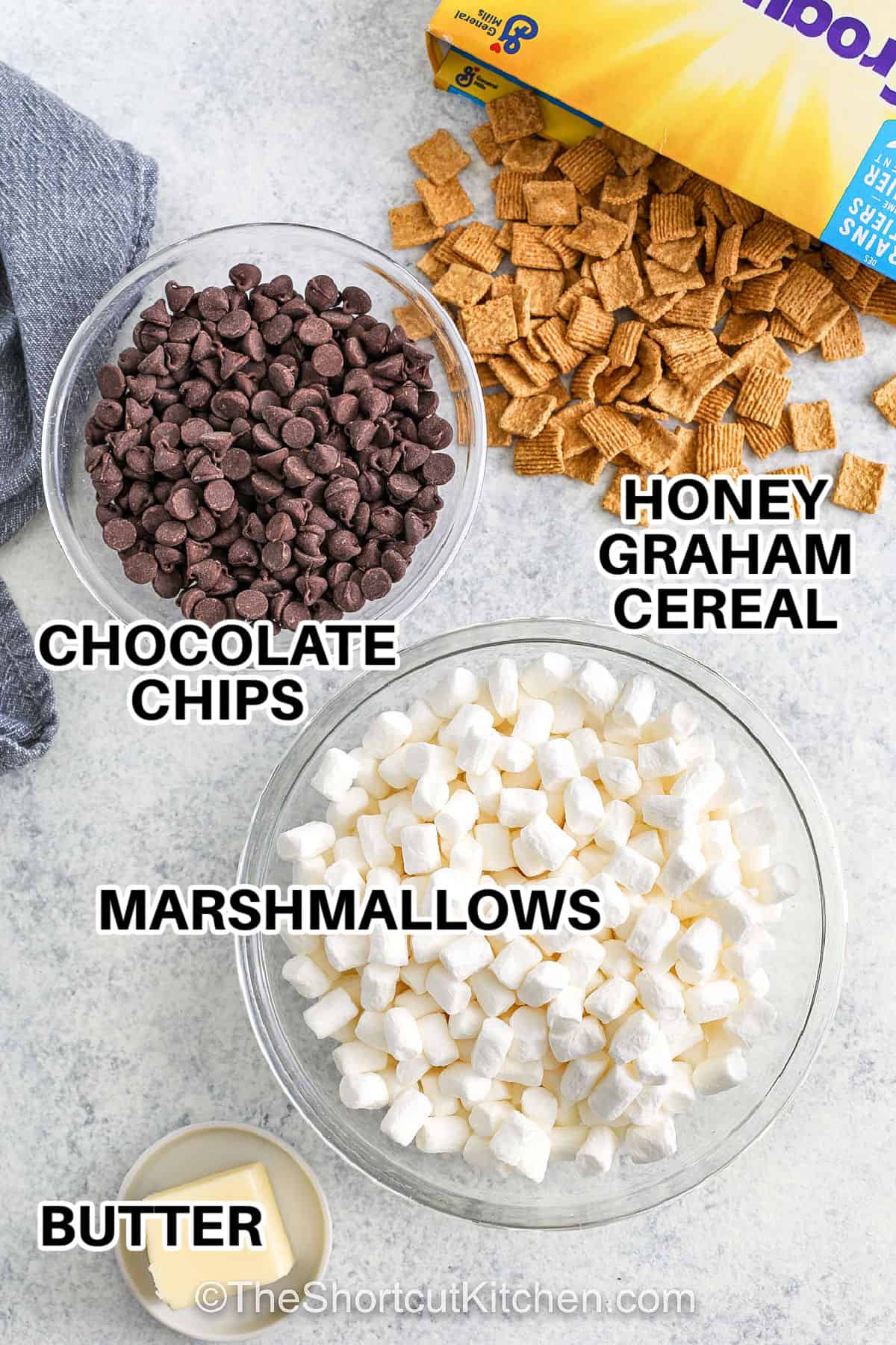 chocolate chips , marshmallows , butter , honey graham cereal with labels to make Smores Bars