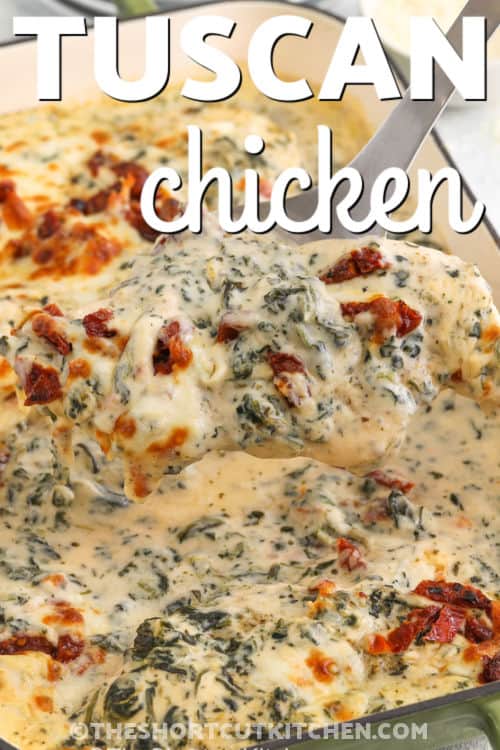 taking a piece of Baked Tuscan Chicken out of the dish with a title