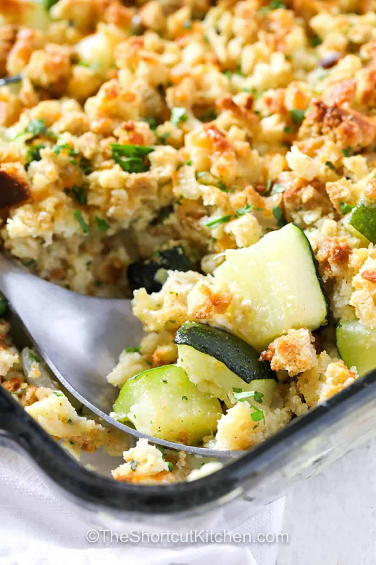 Zucchini Squash Casserole in a dish with a spoon