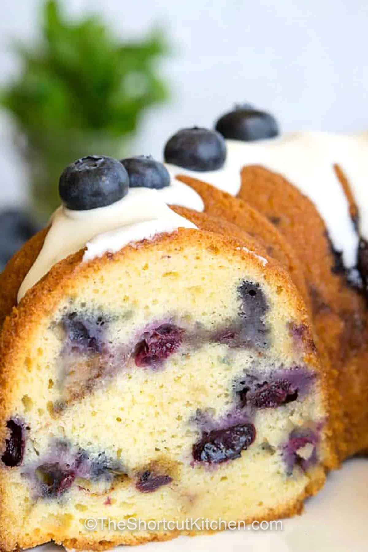 Blueberry coffee cake on a plate cut open to show the inside
