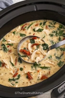 close up of Crockpot Tuscan Chicken Soup in a laddle