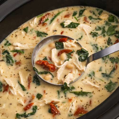 close up of Crockpot Tuscan Chicken Soup in a laddle