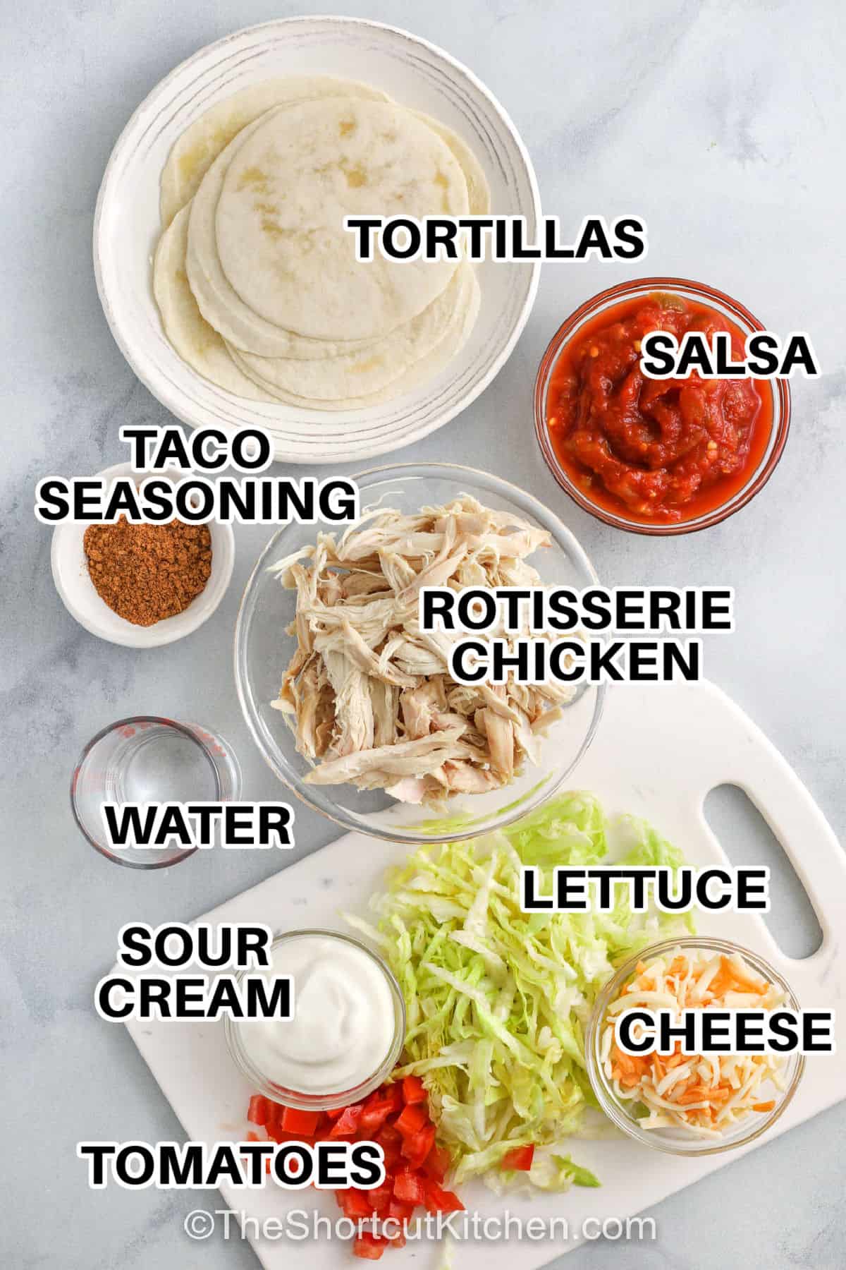tortillas , salsa , taco seasoning , rotisserie chicken , water , sour cream , tomatoes , lettuce and cheese with labels to make Rotisserie Chicken Tacos