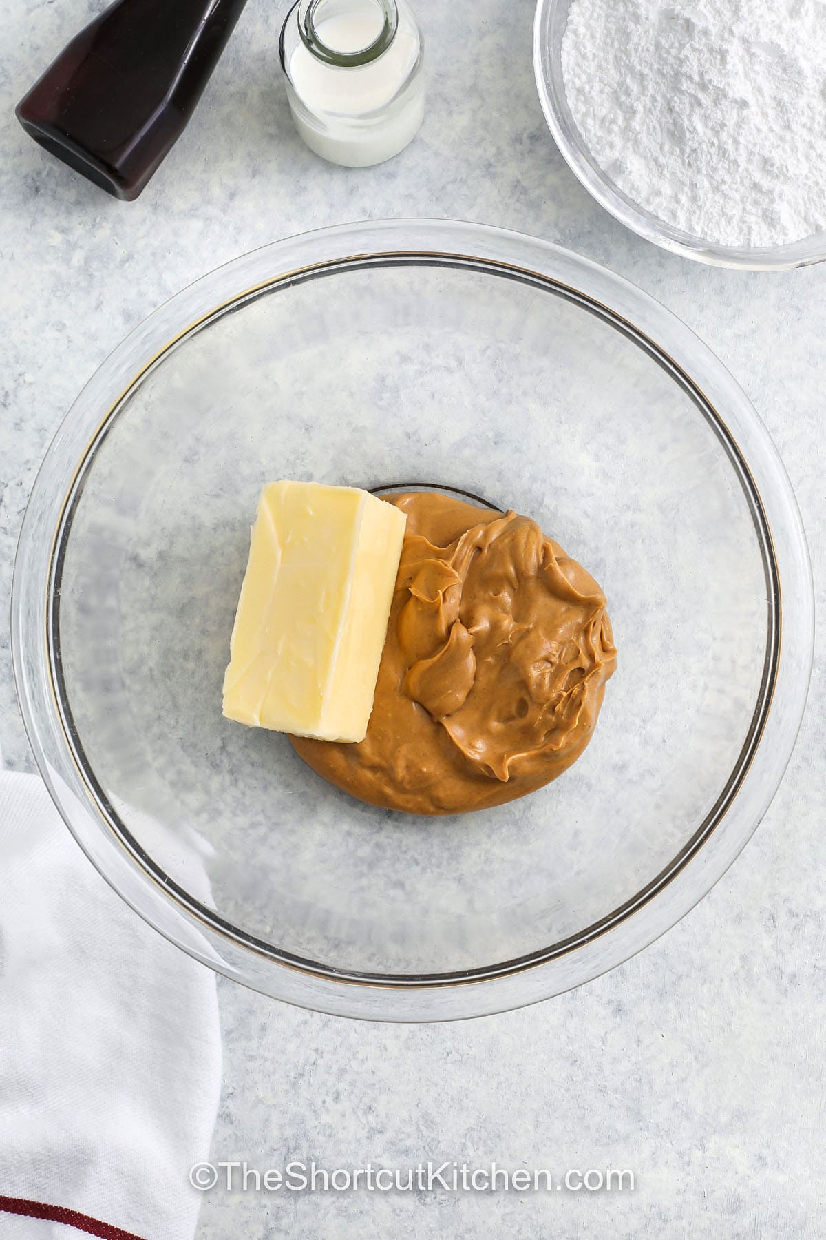 adding butter and peanut butter to bowl to make Peanut Butter Cupcakes