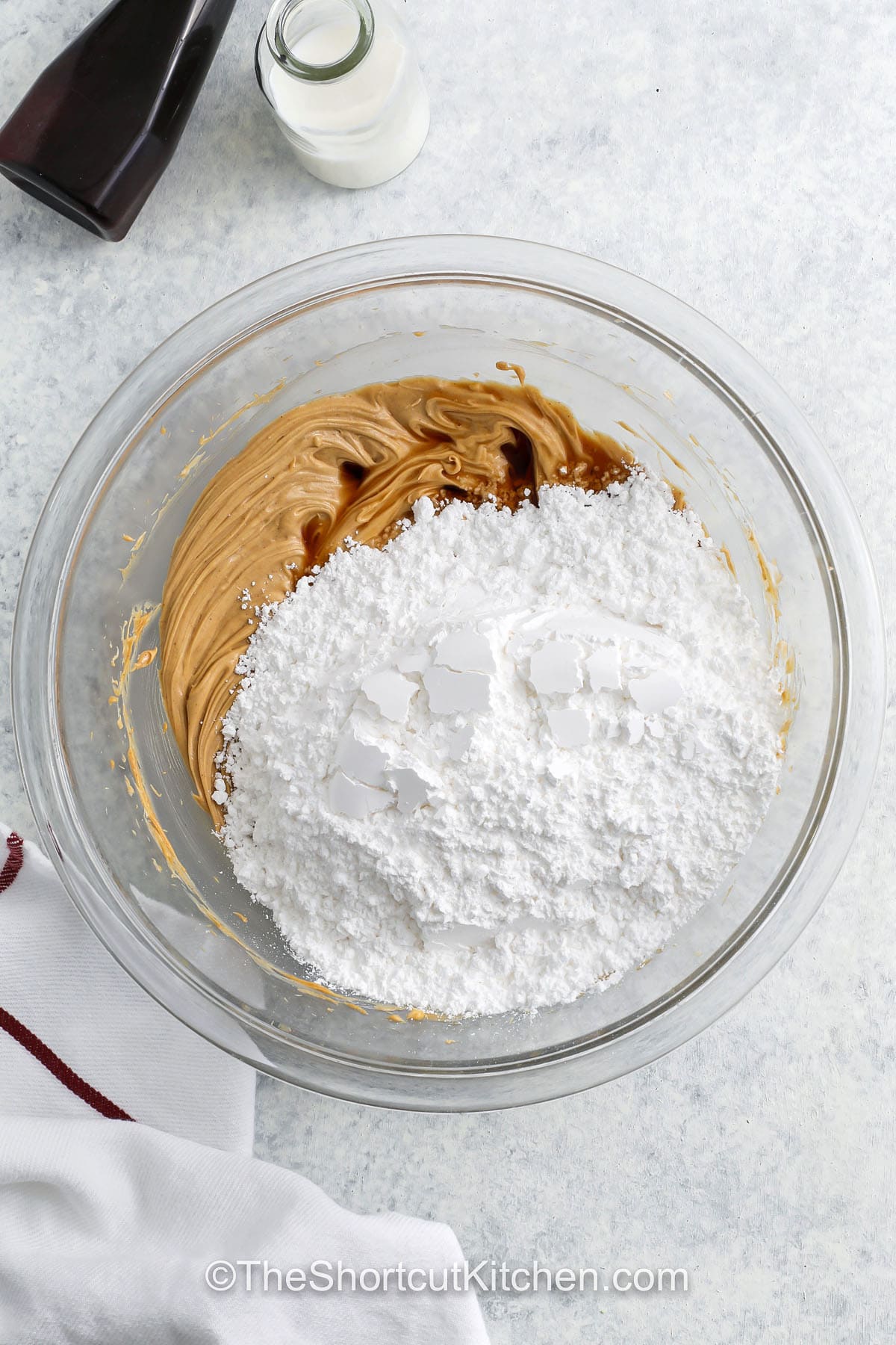 adding powdered sugar and vanilla to peanut butter mixture to make Peanut Butter Cupcakes