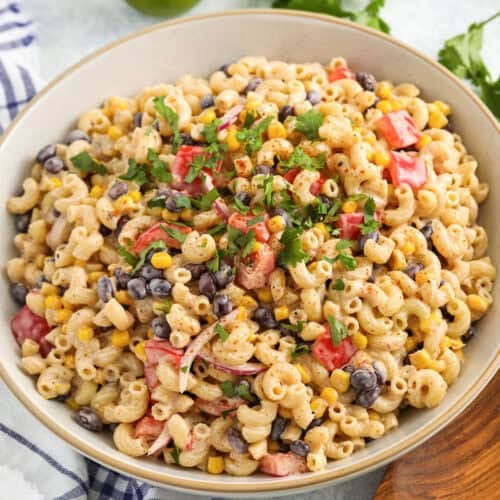 plated creamy Southwest Pasta Salad with a wooden spoon