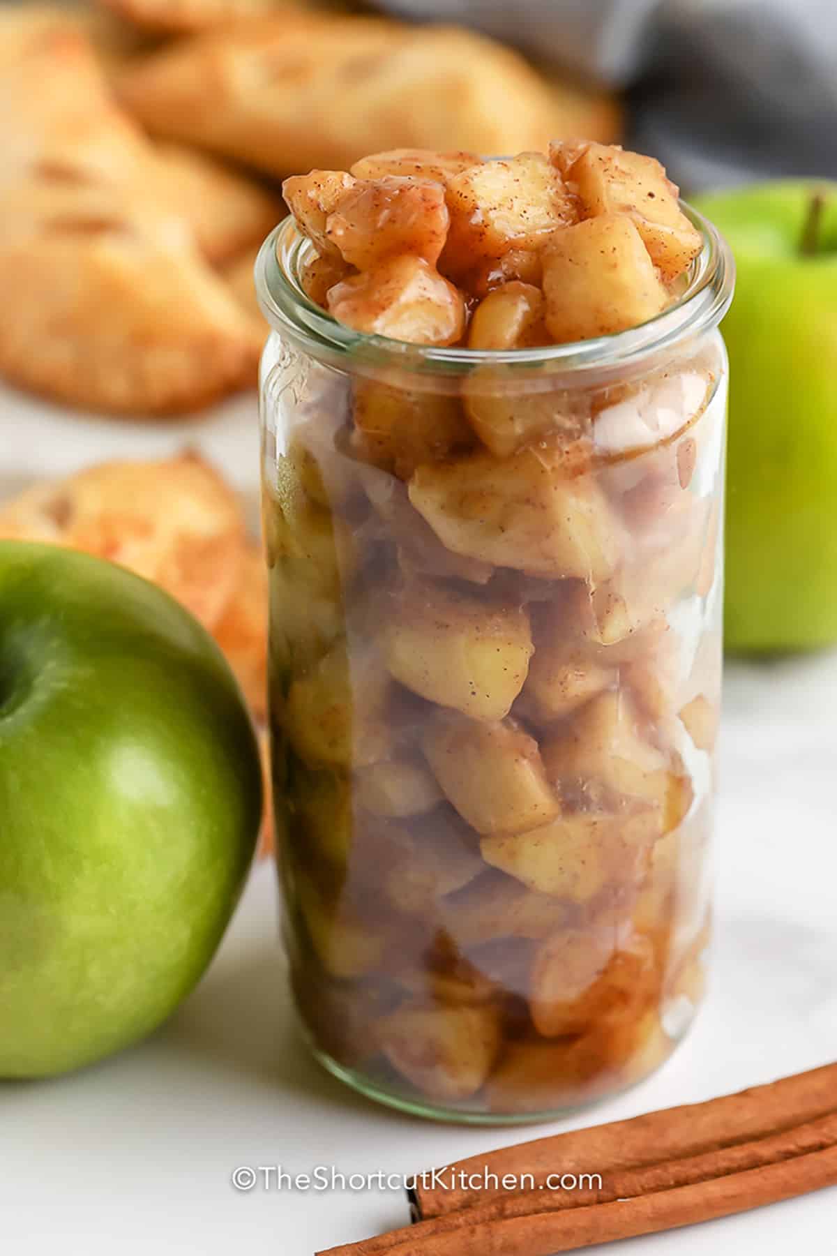 This easy apple pie filling is a simple way to create quick, delicious homemade desserts any time. Fresh apples are peeled, sliced, and cooked from scratch on the stovetop with sugar, spices, and butter. The result is a warm, rich filling that’s ready in minutes. Make it ahead to store in the fridge or freezer for pies, crisps, or cobblers whenever the craving hits. #theshortcutkitchen jar of Easy Apple Pie Filling