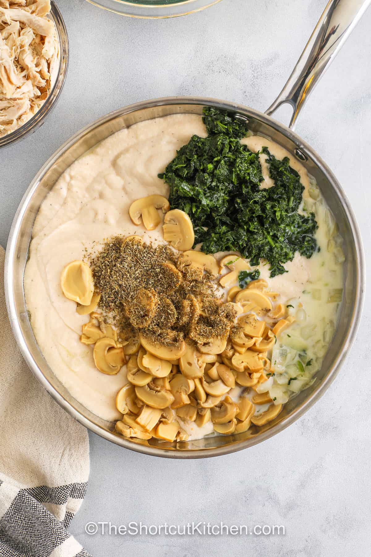 adding ingredients to pan to make sauce for Chicken Alfredo Lasagna Recipe