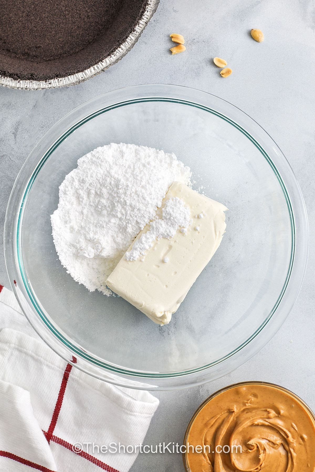 adding powdered sugar and cream cheese together to make Peanut Butter Pie