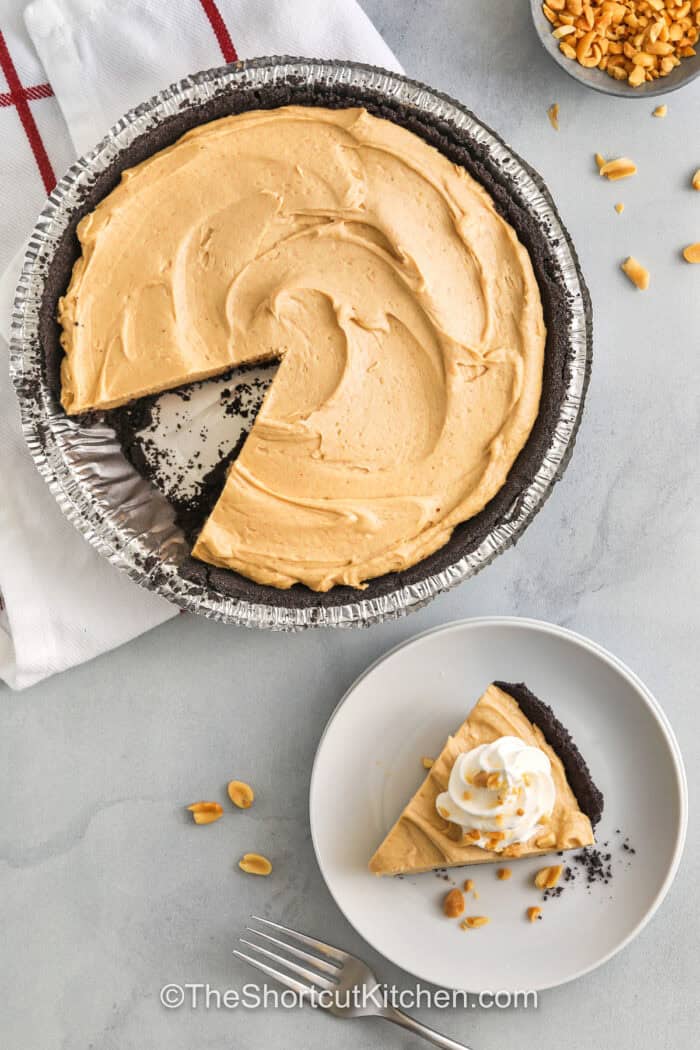taking a slice of Peanut Butter Pie out of the pie and plating