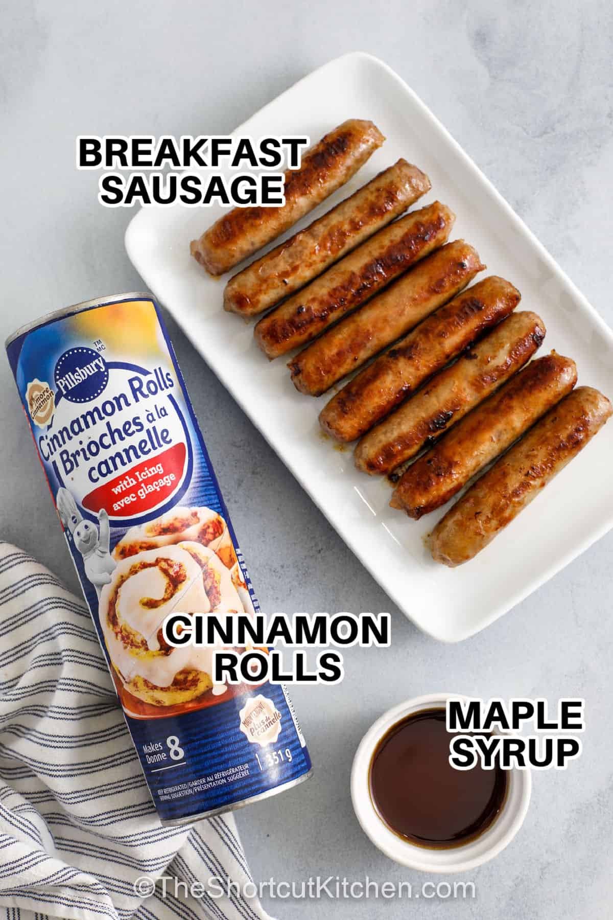 breakfast sausage , cinnamon rolls and maple syrup with labels to make Breakfast Pigs in a Blanket