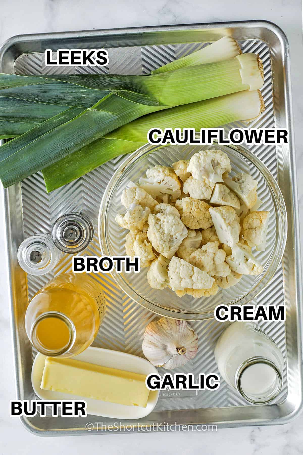 Cauliflower leek soup brings together simple ingredients to create a deliciously smooth and satisfying bowl of warmth. The mild sweetness of leeks pairs perfectly with the nutty flavor of cauliflower, all enhanced by a splash of cream. This soup is cozy, nourishing, and incredibly easy to make in just one pot. Whether served as a starter or main dish, it’s always a hit! #theshortcutkitchen leeks , cauliflower , broth , butter , garlic , cream with labels to make Cauliflower Leek Soup