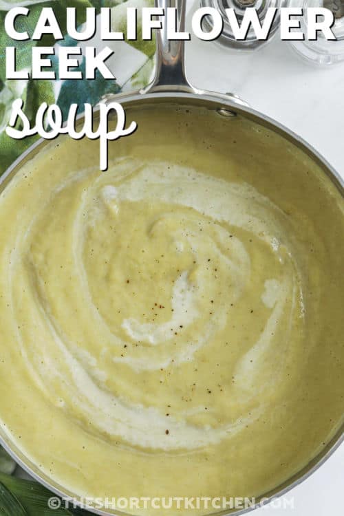 This creamy cauliflower leek soup is the perfect comfort food, made with fresh cauliflower, tender leeks, and a rich blend of butter, olive oil, and garlic. Simmered in chicken broth and finished with heavy cream, it’s velvety smooth and full of flavor. A quick blend with an immersion blender gives it the perfect texture. Great for chilly nights or easy lunches. Ready in under an hour! #theshortcutkitchen Cauliflower Leek Soup with a title