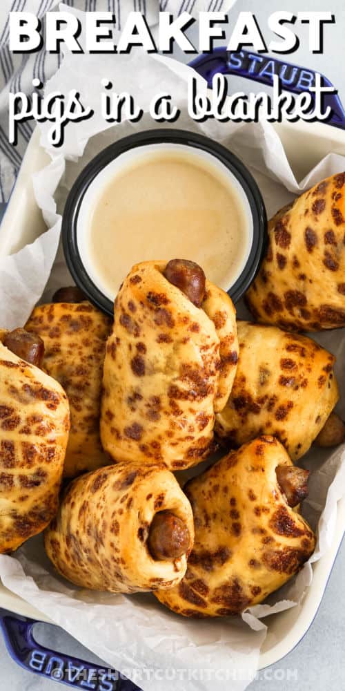 Breakfast Pigs in a Blanket in a dish with dip and a title