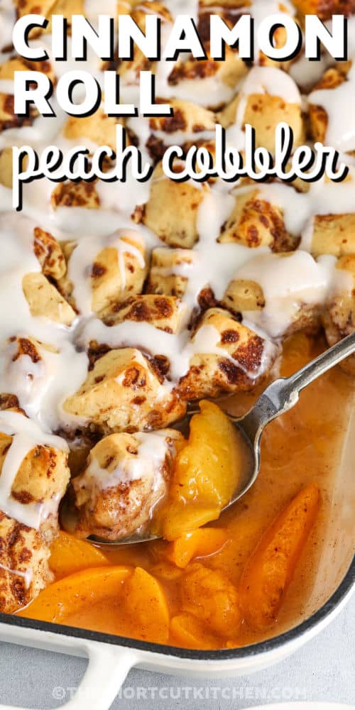 sweet Cinnamon Roll Peach Cobbler in the casserole dish with writing