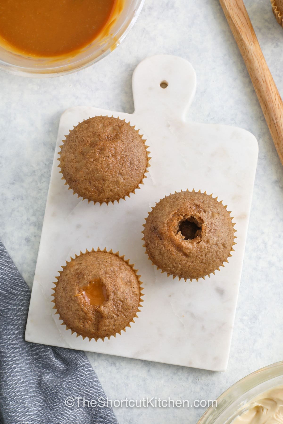 adding caramel filing to Salted Caramel Cupcakes