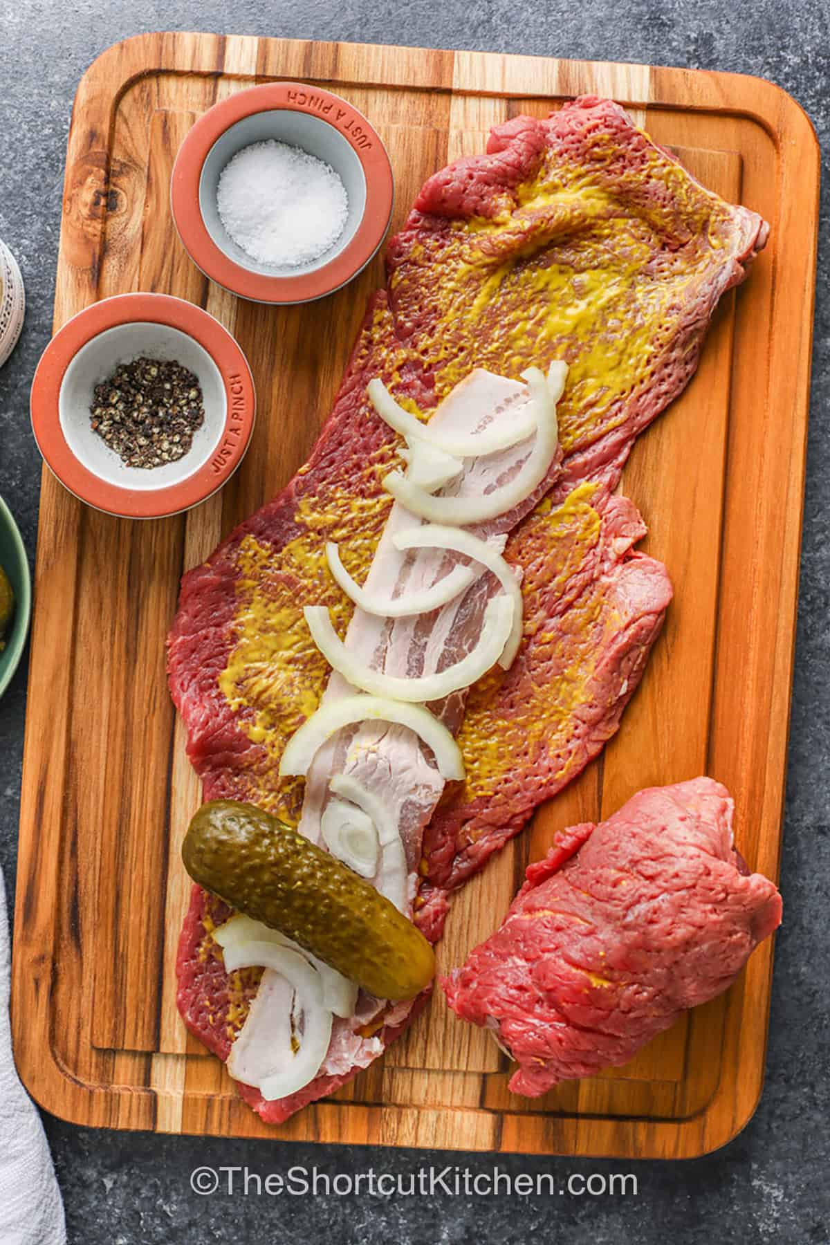 rolling ingredients in beef to make Beef Rouladen