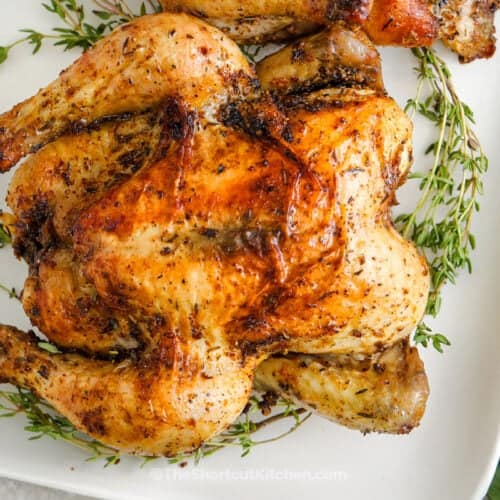 Baked Cornish Hens on a serving platter with thyme