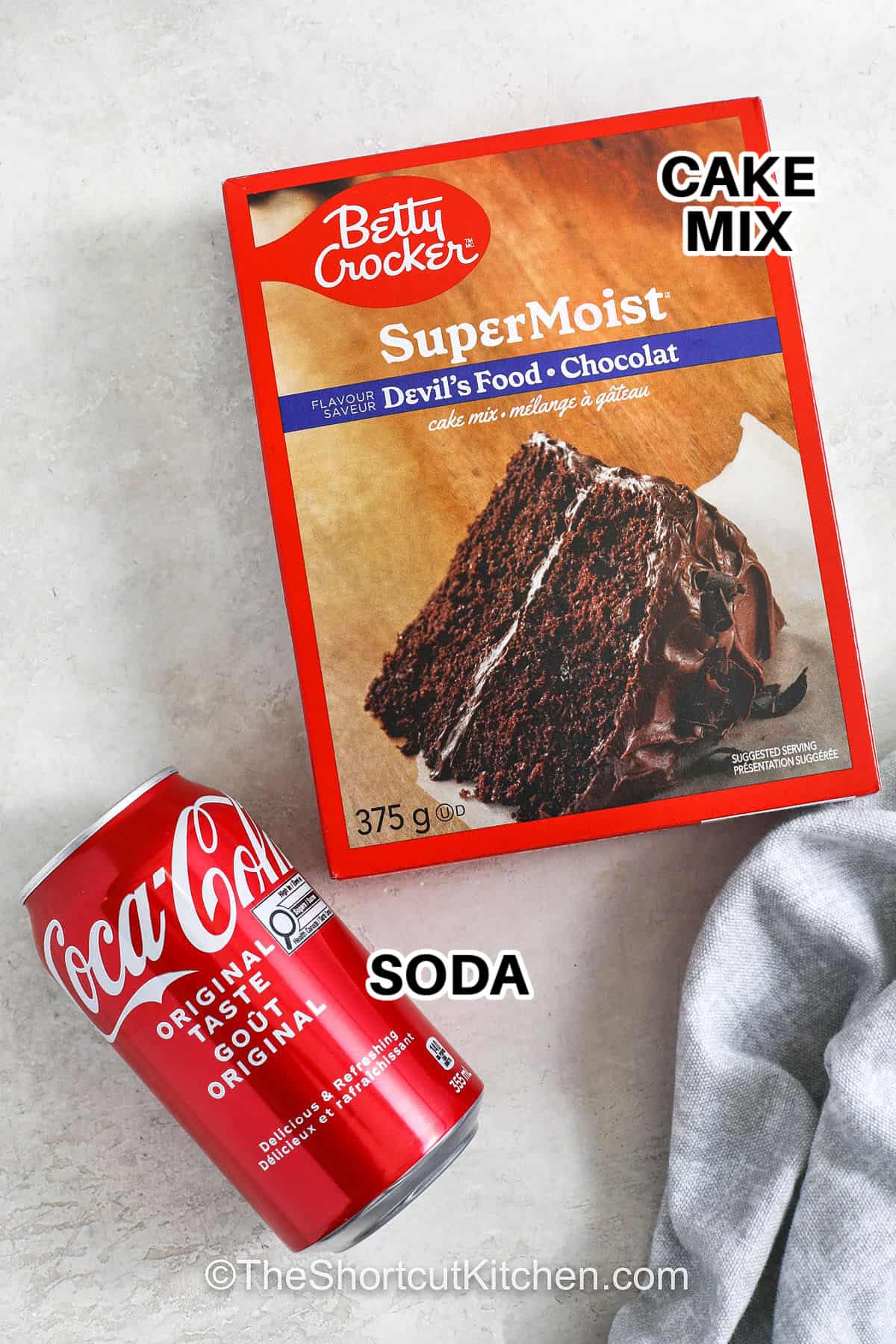 Cake mix soda cake brings together a box of cake mix and a can of pop for a sweet and simple dessert. This two-ingredient recipe makes baking fun and easy, and the texture is soft and light. You can make it your own with frosting or whipped topping and serve it for any party or birthday. It’s a quick way to turn basic ingredients into something everyone loves. #theshortcutkitchen cake mix and soda with labels to make Cake Mix Soda Cake