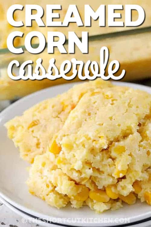 creamed corn casserole on a white plate with writing