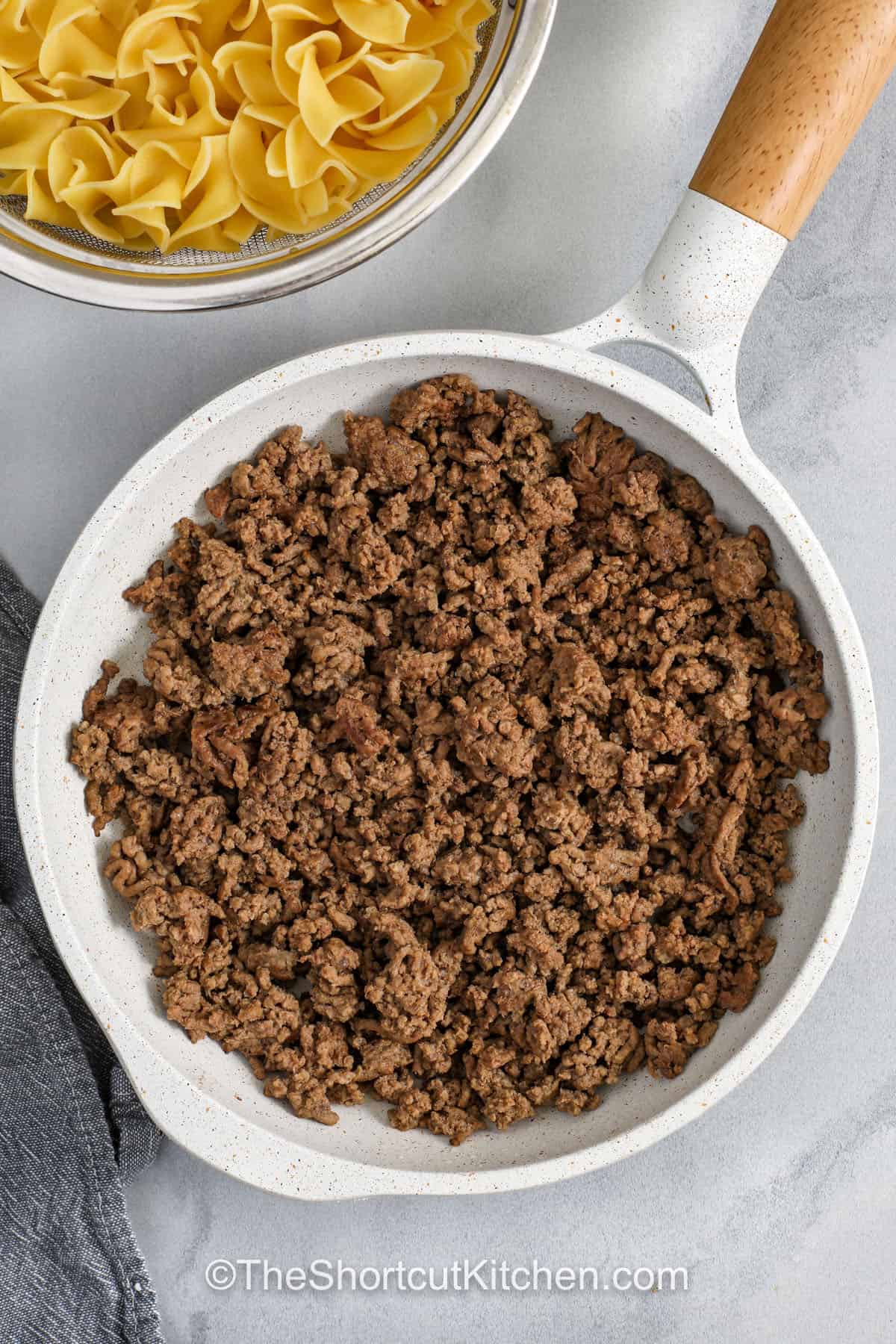 Beef noodle casserole brings together hearty beef, soft noodles, and creamy sauce in a family-friendly meal that’s simple to make and impossible to resist. The combination of tomato and mushroom soups, sour cream, and melted cheddar creates layers of flavor and texture. Perfect for cozy nights, this casserole is baked until golden and bubbling, delivering comfort in every forkful. #theshortcutkitchen cooking beef to make Beef Noodle Casserole