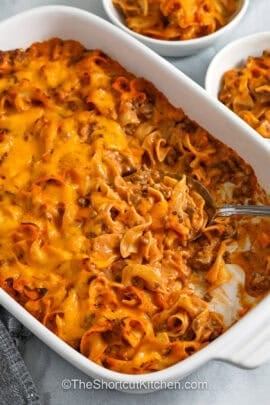 taking a spoonfull of cheesy Beef Noodle Casserole out of the casesrole dish