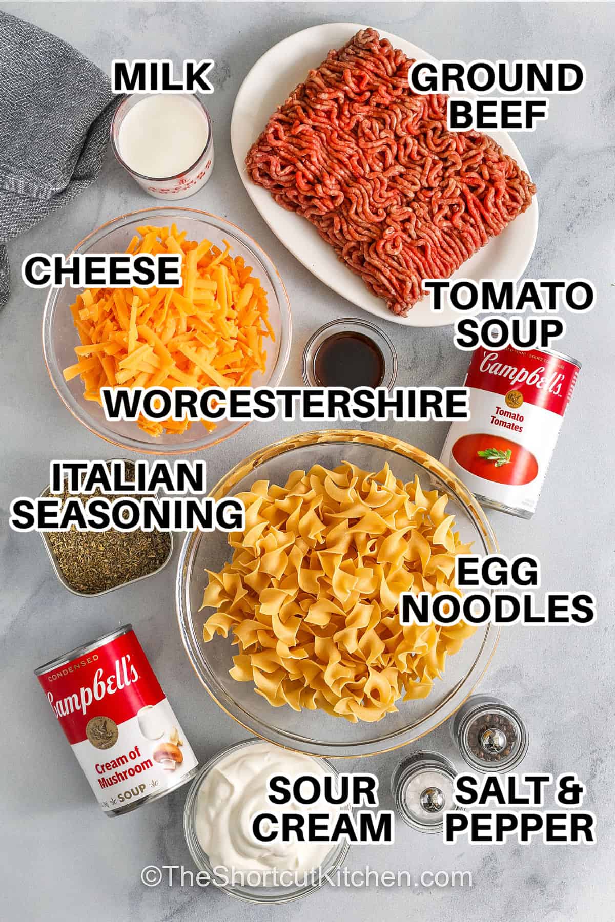 Beef noodle casserole is a creamy, cheesy, and comforting dinner everyone will love. Made with ground beef, egg noodles, two kinds of soup, sour cream, and cheddar cheese, it’s baked to a bubbling, golden finish that’s both hearty and satisfying. Perfect for busy weeknights or family gatherings, it’s an easy dish that fills your home with warmth and delicious aroma. #theshortcutkitchen milk , ground beef , cheese , Worcestershire sauce , italian seasonings , cream of mushroom soup , sour cream , salt and pepper , egg noogles , tomato soup with labels to make Beef Noodle Casserole