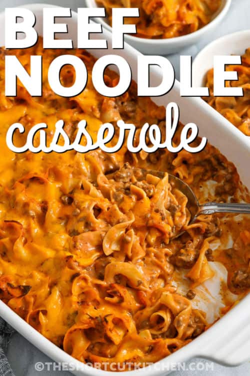 Beef noodle casserole is the ultimate cozy dinner, layered with tender egg noodles, seasoned ground beef, and a creamy blend of mushroom and tomato soups. Sour cream and milk add rich smoothness, while melted cheddar cheese brings gooey, golden perfection. Every bite is warm, hearty, and satisfying. It’s easy to make, family-friendly, and perfect for any night. #theshortcutkitchen hearty Beef Noodle Casserole in a casserole dish and in bowls with writing