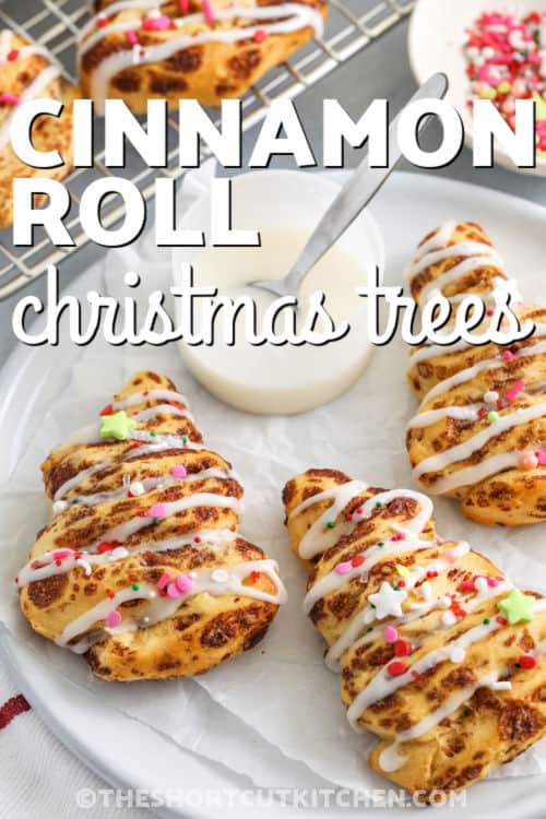 Cinnamon roll Christmas tree delights are a quick, festive way to enjoy classic cinnamon rolls. Shaped into cheerful trees, baked to golden perfection, and topped with sweet icing and colorful sprinkles, they are soft, fluffy, and full of cinnamon flavor. Ideal for holiday breakfasts, brunches, or parties, these adorable pastries make the season feel extra merry and bright. #theshortcutkitchen close up of warm Cinnamon Roll Christmas Tree with a title