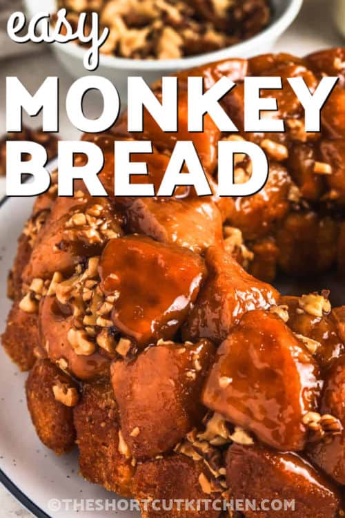 Easy monkey bread is a sweet family favorite with cinnamon sugar on every gooey piece, plus a buttery caramel topping that bakes into a sticky pull apart loaf. This simple dish fits in with breakfast or brunch and brings cozy flavor to any holiday meal. It is great for sharing because everyone can grab a piece straight from the warm pan, making it a no fuss way to bring people together for something special. #theshortcutkitchen Easy Monkey Bread on a plate with writing