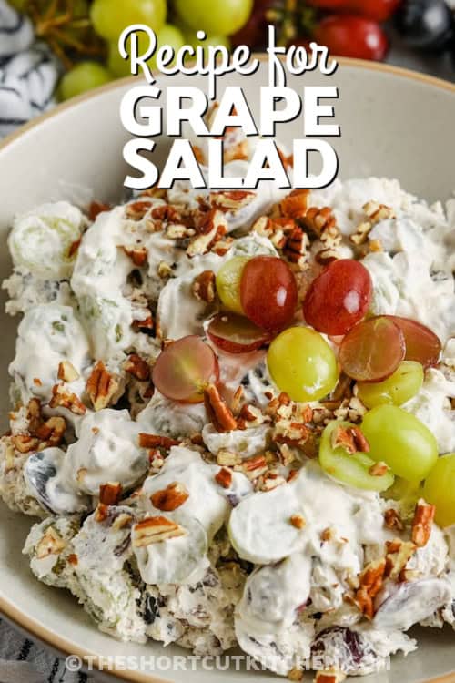 This recipe for grape salad features sweet grapes folded into a fluffy mix of cream cheese, sour cream, brown sugar, and vanilla extract. Once chilled, it's finished with chopped pecans for texture and optional extra sweetness. Simple, delicious, and irresistibly creamy, it’s perfect for gatherings or meal prep. A tasty twist on traditional fruit salad, with minimal effort and max flavor. #theshortcutkitchen grape salad in a bowl with a title