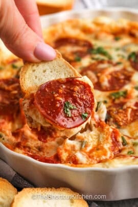 dipping bread in Pizza Dip Recipe