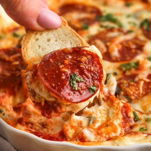 dipping bread in Pizza Dip Recipe