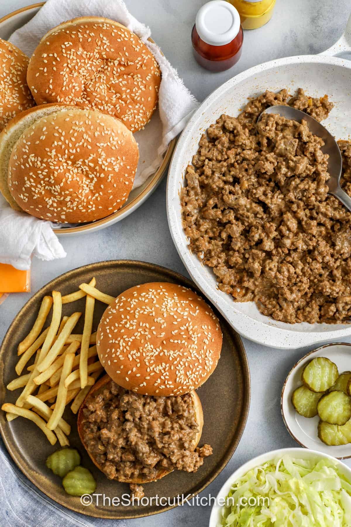 If you love cheeseburger sloppy joes, try these Big Mac Sloppy Joes. The ground beef simmers in a quick “special sauce” blend using Thousand Island dressing, mustard, ketchup, and onion powder. Spoon onto buns and add pickles, American cheese, and shredded lettuce for crunch. Easy, saucy, and made with simple ingredients you probably already have. #theshortcutkitchen top view of big mac sloppy joes