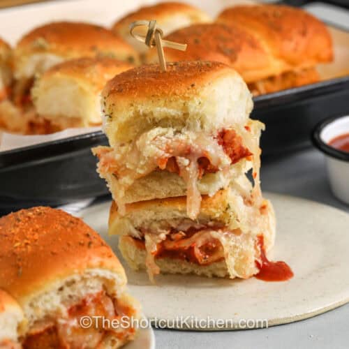 chicken parm sliders on a plate with a pan