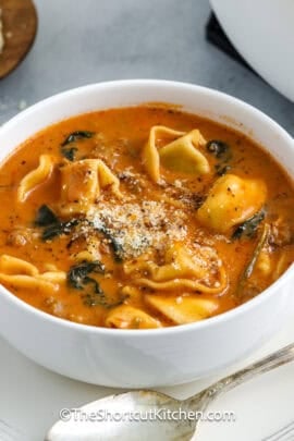 bowl of creamy tortellini soup with spoon