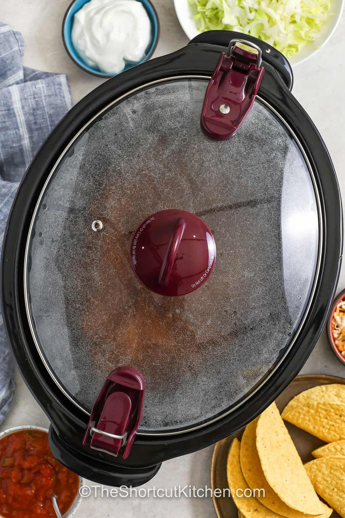 Make the easiest Crockpot taco meat using ground beef, taco seasoning, and a jar of salsa for bold, saucy flavor with zero fuss. This hands-off slow cooker taco meat cooks until tender and scoopable, ideal for tacos, burrito bowls, nachos, or meal prepping for the week. A dependable weeknight recipe that turns basic ingredients into a crowd-pleasing taco filling. #theshortcutkitchen Crockpot Taco Meat cooking in the pot