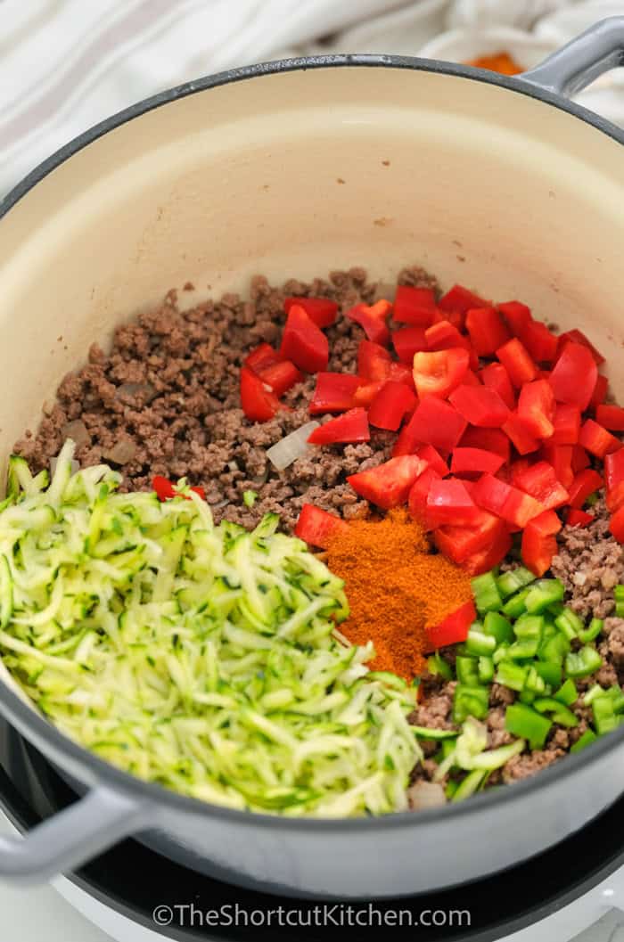 Warm and cozy easy chili with ground beef, beans, tomatoes, and a thick tomato base that’s perfect for toppings. This homemade chili is a one-pot stovetop recipe with simple pantry ingredients and a simmer that builds big flavor. Adjust chili powder to control heat, add broth if it gets too thick, and freeze extra servings for quick dinners later. #theshortcutkitchen ingredients for easy chili in a pot