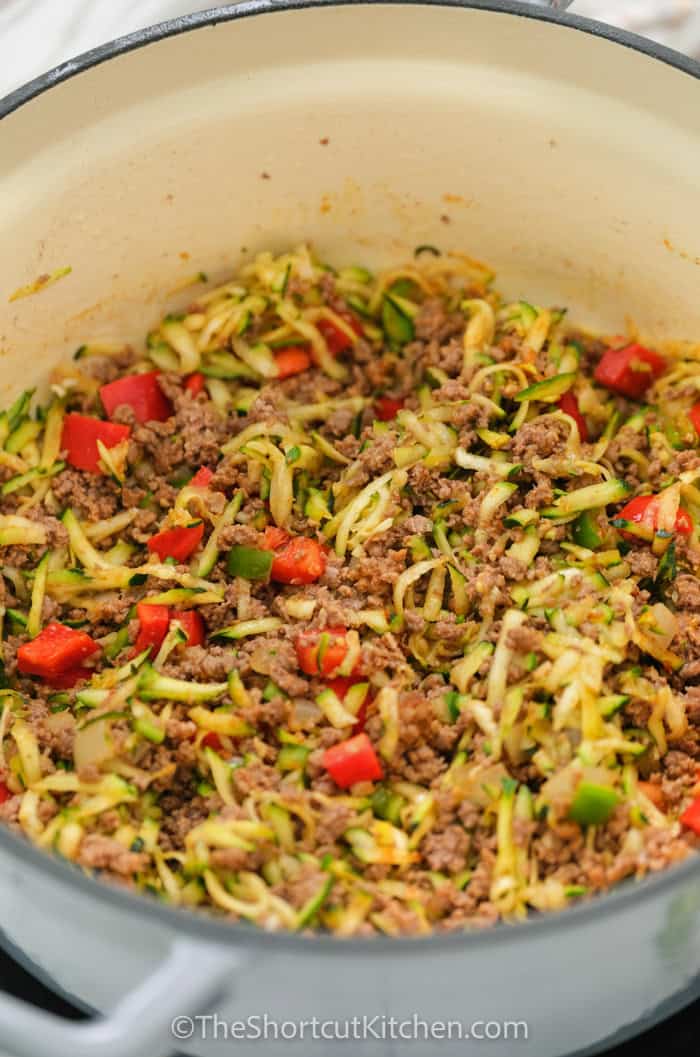 This easy chili is hearty, rich, and made with ground beef, kidney beans, diced tomatoes, tomato sauce, and simple spices. A true quick and easy chili for weeknight dinner, game day, or a chili bar. Simmer until thick and glossy, then serve with cheese and sour cream. Leftovers reheat beautifully and make the best next-day lunch. #theshortcutkitchen ingredients for easy chili cooked in a pot