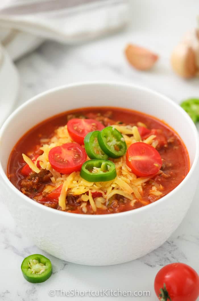 Cozy up with easy chili made from ground beef, kidney beans, diced tomatoes, tomato sauce, and beef broth. This homemade chili is beginner-friendly and perfect for weeknights because it uses pantry staples and one pot. Simmer until thick, then taste and adjust the spice level. Serve over baked potatoes or with cornbread, and store leftovers for easy lunches. #theshortcutkitchen bowl of easy chili