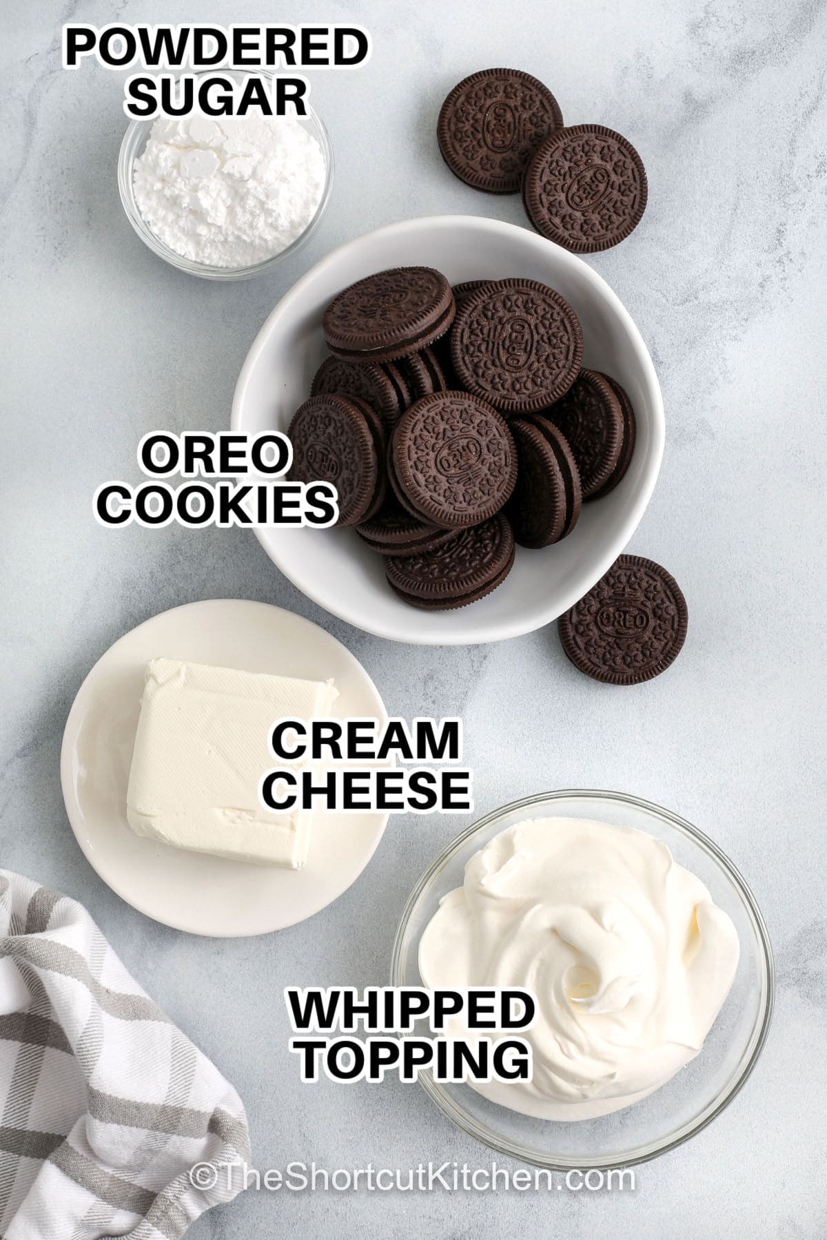 Oreo dip is the easiest cookies and cream dip to make, using just cream cheese, whipped topping, powdered sugar, and crushed Oreo cookies. This no bake Oreo dessert dip is light, fluffy, and perfect for serving at parties or as a simple sweet treat. Pair it with pretzels, apple slices, vanilla wafers, or more cookies for a dessert spread everyone will devour. #theshortcutkitchen powdered sugar , oreo cookies , cream cheese , whipped topping with labels to make Oreo Dip