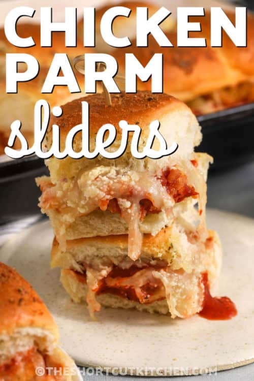 Chicken parm sliders made the shortcut way. Use frozen chicken tenders (cut to fit) or nuggets, add marinara, mozzarella, and parmesan, then bake on Hawaiian rolls with a garlic butter topping. These chicken parmesan sliders come out melty and golden, perfect for feeding a group. Serve with extra marinara for dipping and a simple salad on the side. #theshortcutkitchen stacked chicken parm sliders with writing