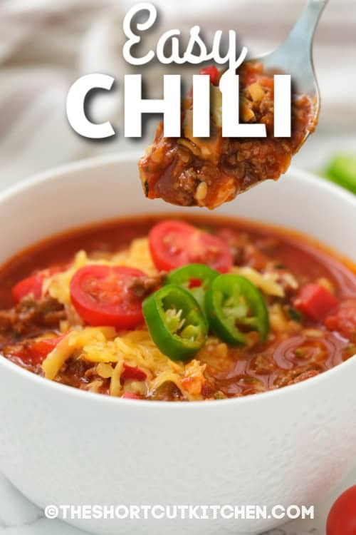 This easy chili recipe is packed with ground beef, beans, tomatoes, and classic seasonings for a rich, cozy flavor. It’s a quick and easy chili made in one pot with minimal prep, then simmered uncovered until thick and scoopable. Top with cheddar, jalapeños, or crushed tortilla chips. Great for meal prep, and it freezes well for future dinners. #theshortcutkitchen bowl of easy chili with text