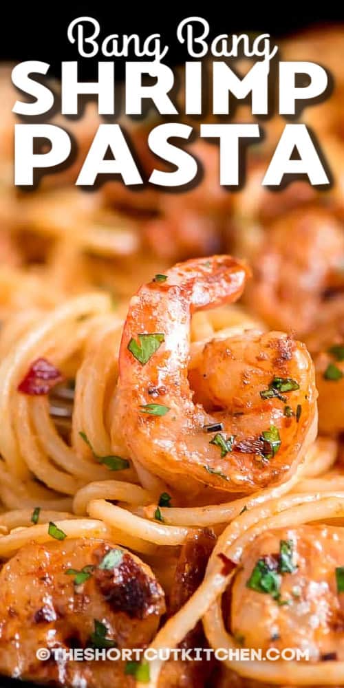 Bang Bang Shrimp Pasta is the shortcut dinner that tastes just as good as takeout. Spaghetti and sautéed shrimp get tossed in a creamy bang bang sauce made with mayonnaise (or Greek yogurt), sweet Thai chili sauce, lime, and sriracha. Garlic-butter shrimp sears fast, then everything gets assembled in one skillet and finished with cilantro and red pepper flakes. This recipe makes a sweet chili shrimp pasta that’s ready in about 20 minutes. #theshortcutkitchen scoop of bang bang shrimp pasta with text