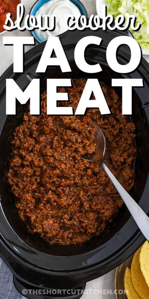 Crockpot Taco Meat in the pot with toppings around it and a title
