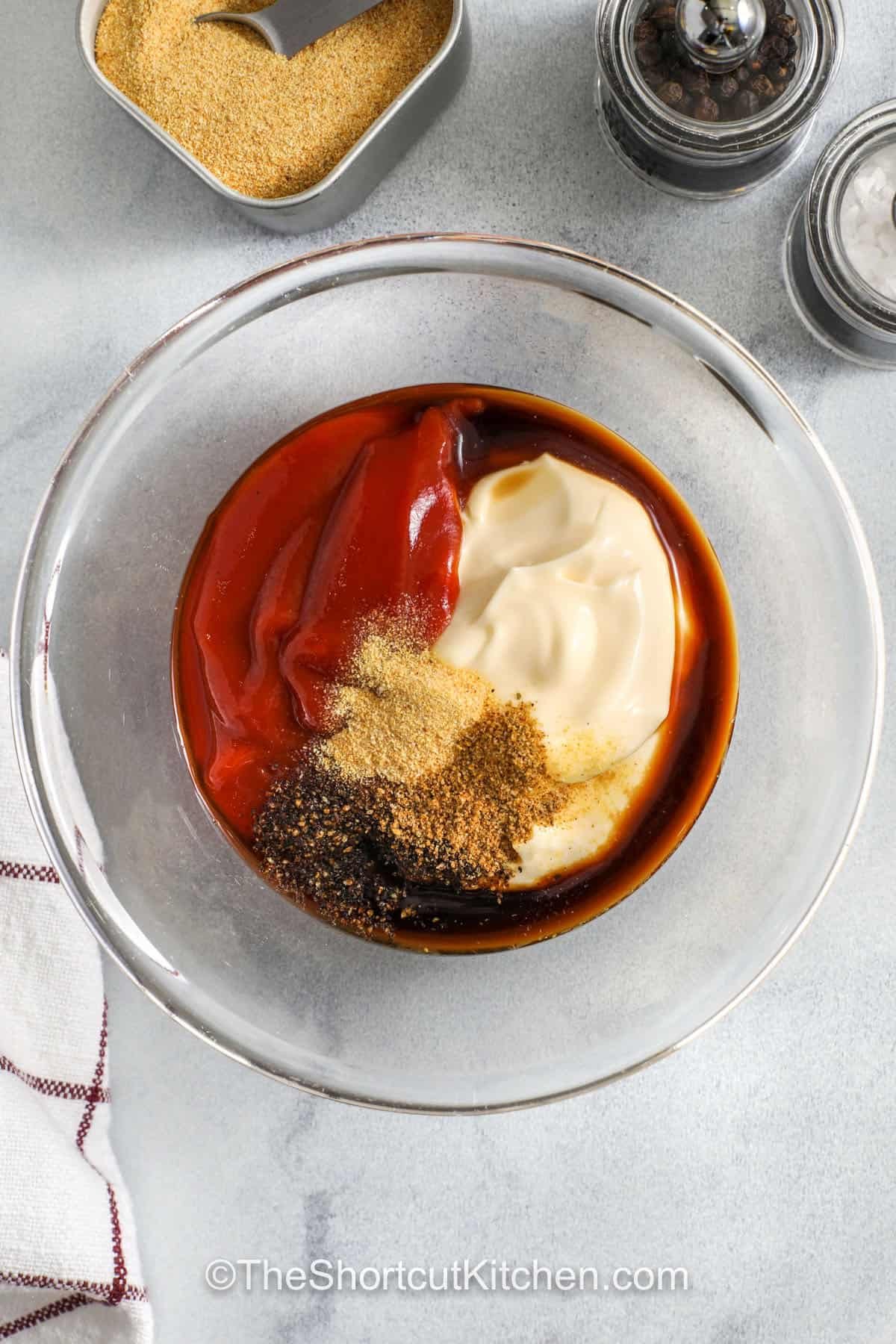 This canes sauce copycat is the fast way to upgrade frozen chicken tenders and air fryer fries. Mayonnaise keeps it thick and creamy, ketchup adds tang, Worcestershire brings savory flavor, and pepper makes it pop. Chill for at least 30 minutes so the flavors blend. A must-have chicken finger sauce for busy nights. #theshortcutkitchen adding ingredients to bowl to make Cane Sauce